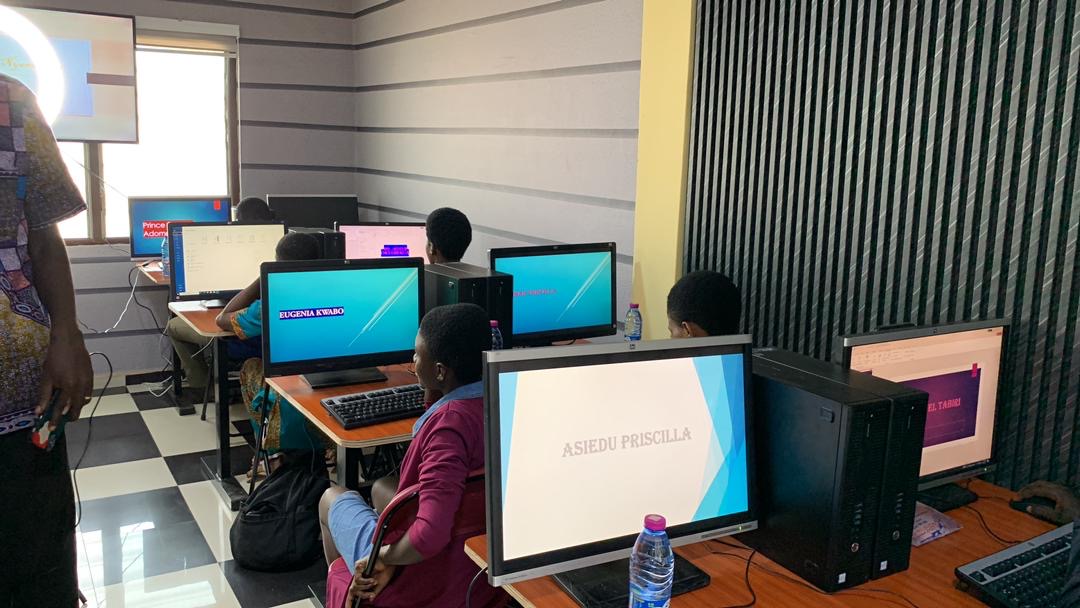 Young people learning computer skills at ThriveWorks Ghana in Abesim.